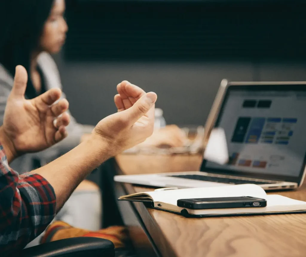 Digital marketing consultant reviewing strategy with a small business owner at a laptop
